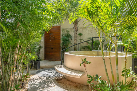 Enjoy a refreshing dip in the shared cold plunge, set among tropical greenery and inviting lounge areas that create a calm, relaxing atmosphere ideal for unwinding.