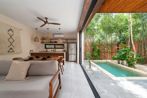 This thoughtfully designed space blends modern elegance and nature. Floor-to-ceiling doors open to a private pool, creating a calm, airy atmosphere ideal for relaxing stays and slow living.