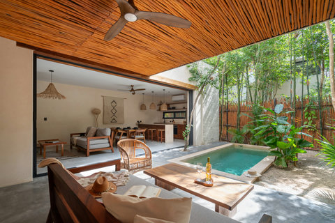 Thoughtfully designed open-concept retreat featuring a private pool, shaded lounge, modern kitchen, and warm textures. A refined tropical escape crafted for comfort, privacy, and memorable stays.