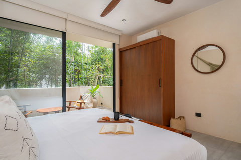 Unwind in our tranquil room featuring a king-size bed, large closet, and balcony access. A calm retreat where comfort and rejuvenation come together seamlessly.