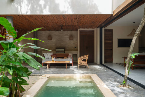 Relax in a tranquil private patio featuring a plunge pool and lush greenery. A cozy seating area provides the perfect spot to unwind, soak up the sun, and enjoy peaceful moments.