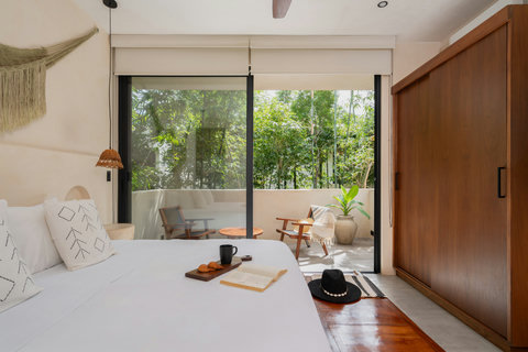 Relax in our serene room with a plush king-size bed, spacious closet and balcony access. A peaceful retreat designed for your comfort and rejuvenation.