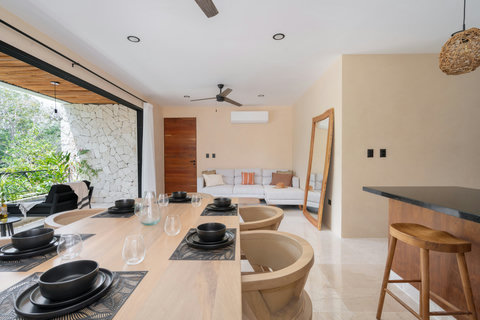 Open-concept living and dining area with modern design, warm wood accents, and abundant natural light. Seamlessly connected to the terrace for a perfect indoor-outdoor experience.