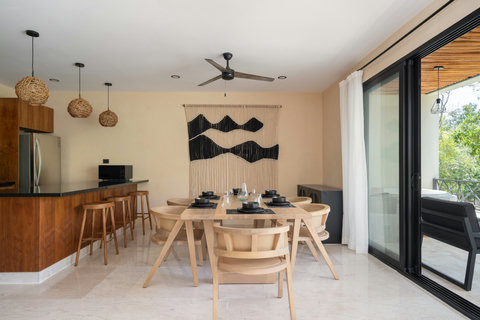 Bright dining area with modern design, warm wood finishes, and seamless access to a private terrace. A stylish space perfect for shared meals and indoor-outdoor living.
