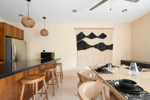 Modern dining area with warm wood finishes, stylish décor, and a sleek breakfast bar. A bright, inviting space perfect for enjoying meals and gathering with friends or family.