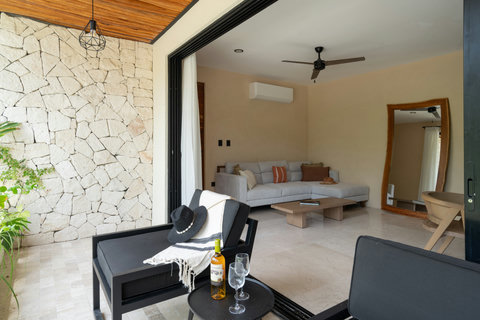 Seamless indoor-outdoor living with a cozy lounge, modern décor, and direct terrace access. A perfect blend of comfort and nature for a relaxing stay.