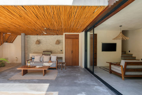 Experience seamless indoor-outdoor living with a cozy lounge area, stylish tropical design, and relaxing open spaces perfect for unwinding in total comfort.