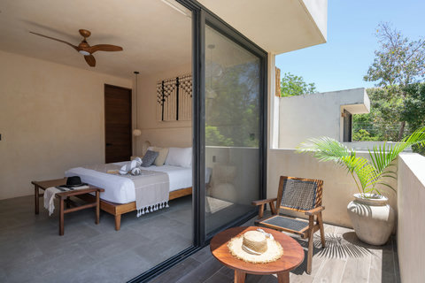Enjoy seamless indoor-outdoor living in this serene king suite with a private balcony, natural light, and calming boho-inspired design touches.