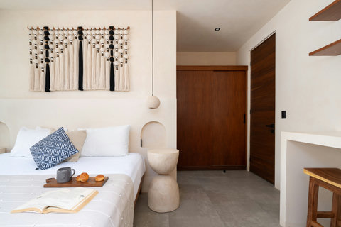 Unwind in this thoughtfully designed king bedroom featuring handcrafted décor, warm wood accents, and a calming atmosphere perfect for restful stays.