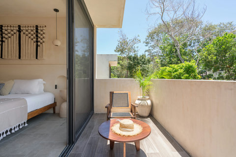Enjoy a peaceful private balcony connected to a cozy boho-style bedroom. Perfect for morning coffee, relaxing in the sun, or unwinding surrounded by tropical greenery.