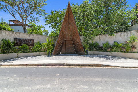Step into a grand, beautifully designed entrance that immediately sets the tone for a luxurious and tranquil stay, blending elegant architecture with the serene essence of Tulum.