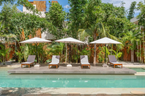 Relax by the pool or take a refreshing swim in this beautiful shared space, featuring plenty of lounge chairs where you can unwind, soak up the sun, and enjoy a laid-back tropical atmosphere.