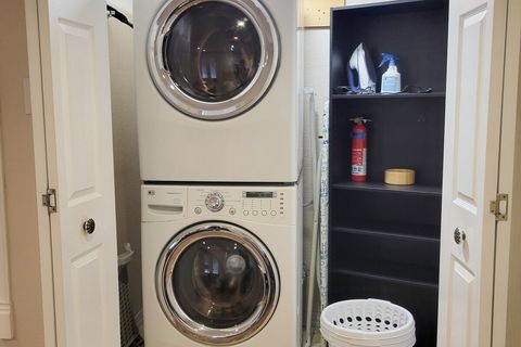 Washer and Dryer with Laundry Detergent, Baskets, Iron, Ironing Board, and Fire Extinguisher