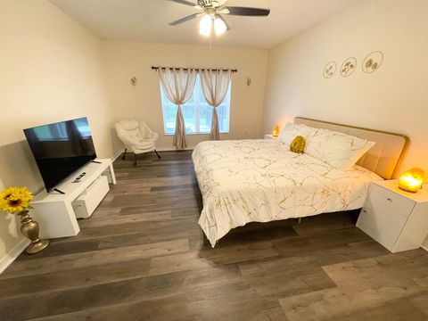Large, downstairs master room with king bed, soothing, Himalayan salt stone lights, night stands with USB ports, and a smart TV.