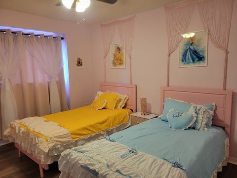 Upstairs, Disney princess-themed bedroom with two twin beds, touchable night light with USB ports, and a smart TV.