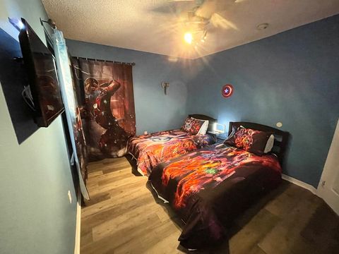 Upstairs, Avengers-themed bedroom with two twin-beds, touchable night light with USB ports, and a smart TV.
