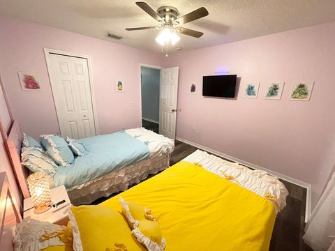 Upstairs, Disney princess-themed bedroom with two twin beds, touchable night light with USB ports, and a smart TV.