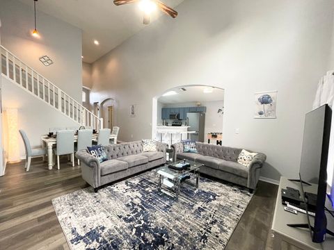 Large living room with 60-inch smart TV with Google Chromecast and 5000-game arcade.