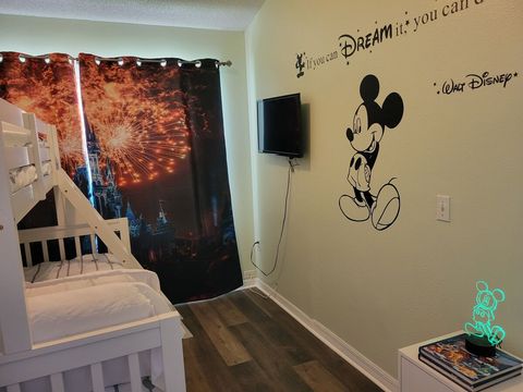 Downstairs, Disney-themed bedroom with twin-over-full bunkbed, color-changing night light, and a smart TV.