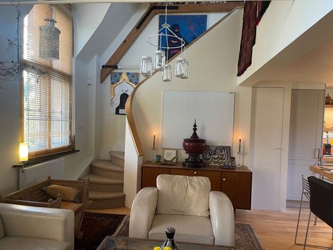 Kitchen/dining room/ reception area and steps leading to the mezzanine.