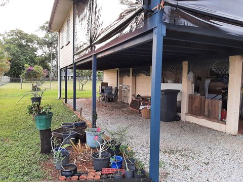 Under the balcony, where the bins are.