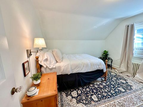 The second bedroom is cozy, and functionally appointed with an alarm clock, white noise machine, and clothing storage.