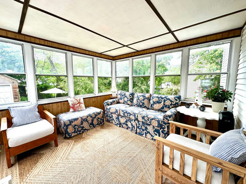 SEASONAL back porch has garden views and provides additional living space during the summer months. 