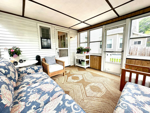 SEASONAL Back porch is enclosed with screens & glass to provide additional living space during the summer months. 