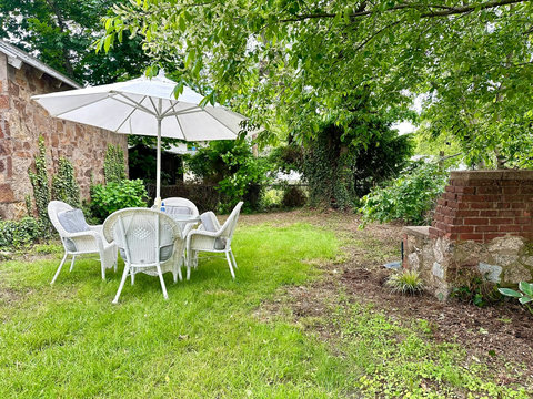 Backyard space with garden views and a patio set with seating for 4 to enjoy meals outdoors in the summer months. 