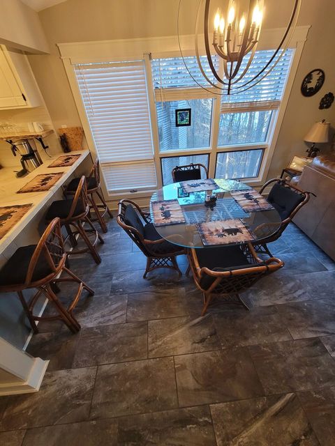 Dining table has 4 chairs and 3 bar stools