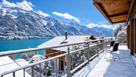 Snowy Chalet Terrace Overlooking Alpine Lake