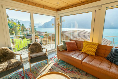 A View Locals Dream About! ✨ Your Swiss Dream Living experience is here. Panoramic windows showcase the magnificent Lake Brienz and mountain views. Enjoy unparalleled natural light from the comfort of our luxury leather seating