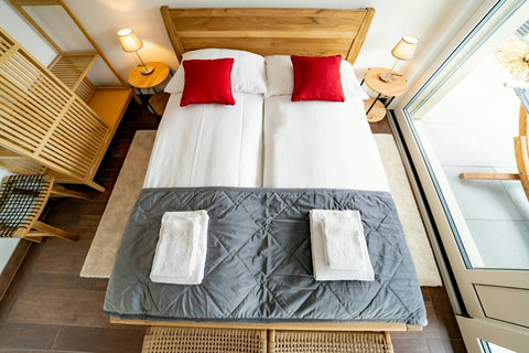 Bedroom 1 offers versatile sleeping arrangements with a Queen-size bed and a double bunk bed, comfortably accommodating up to 4 guests. For added relaxation and style, the room also features a cozy hammock