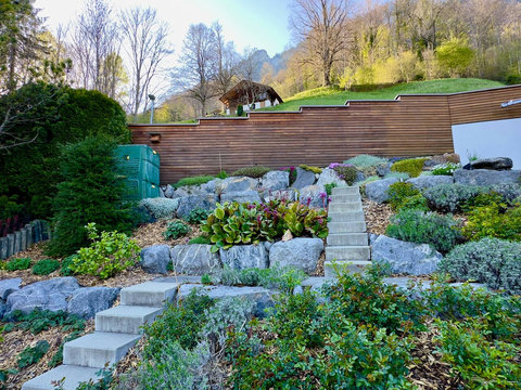 Professionally Terraced Alpine Garden.  Unique, multi-level rock landscaping and steps leading to the upper hillside. Meticulously designed to blend seamlessly with the Swiss Alps environment. Just one more luxury touch from Swiss Dream Living.