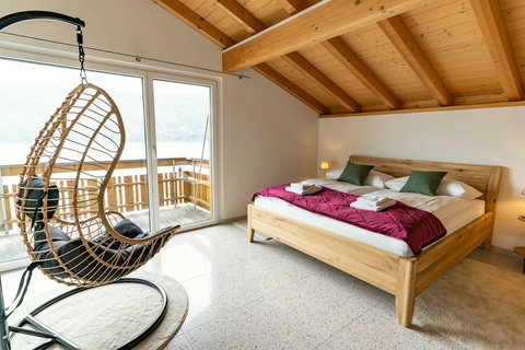 iew Made Famous by K-Drama!  Wake up to this spectacular Lake Brienz view where Crash Landing on You was filmed (Iseltwald). King Bed, private balcony access, and a cozy hanging chair under the stunning vaulted Attic ceiling.