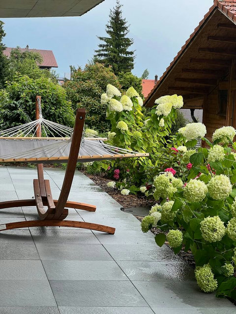 Tranquil Garden Retreat.  Find your peaceful moment in our comfortable hammock, surrounded by beautiful Swiss flora. Perfect for reading, napping, or simply listening to nature.
