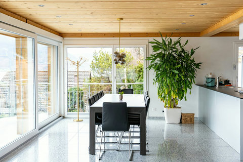 Spacious Dining with a View! ️ Gather your group around the solid 10-seater dining table for memorable meals. Enjoy abundant natural light and seamless access to the outdoors. The perfect social hub for your entire Swiss Dream Living group escape.