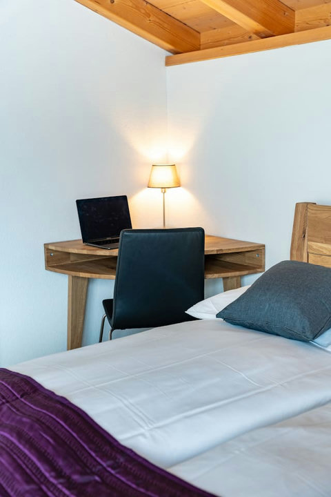 Remote Work with a View.  Designated workspace (desk) and comfortable bed offer the best of both worlds. Seamlessly blend work and leisure in your Swiss Dream Living suite.