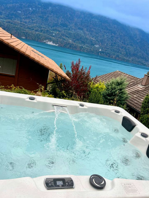 Hydro-Massage Heaven!  Indulge in our private outdoor hot tub featuring powerful massage jets and a waterfall cascade. The ultimate relaxation with direct, uninterrupted views of Lake Brienz. A cornerstone of your Swiss Dream Living experience.