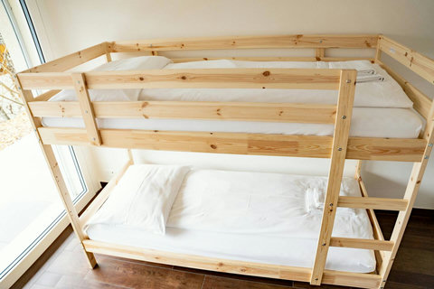 Bedroom 1 offers versatile sleeping arrangements with a Queen-size bed and a double bunk bed, comfortably accommodating up to 4 guests. For added relaxation and style, the room also features a cozy hammock