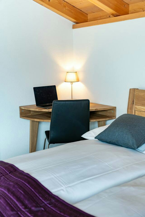 Bedroom-4  features a queen sized bed along with a dedicated work space