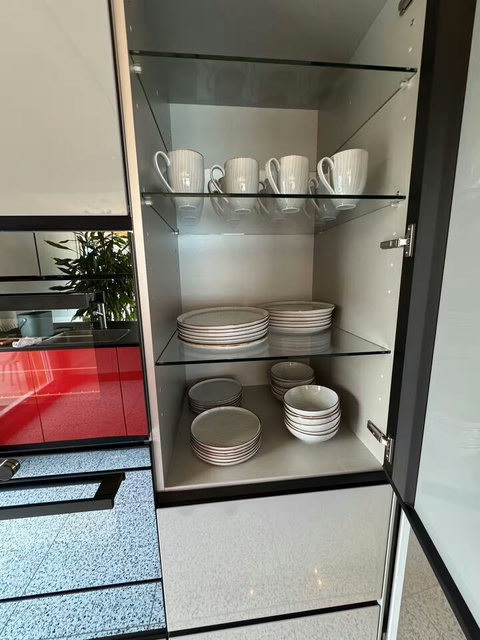 High-quality plates, bowls, and mugs are organized and ready for your group's use. Every detail managed for your effortless Swiss Dream Living stay.