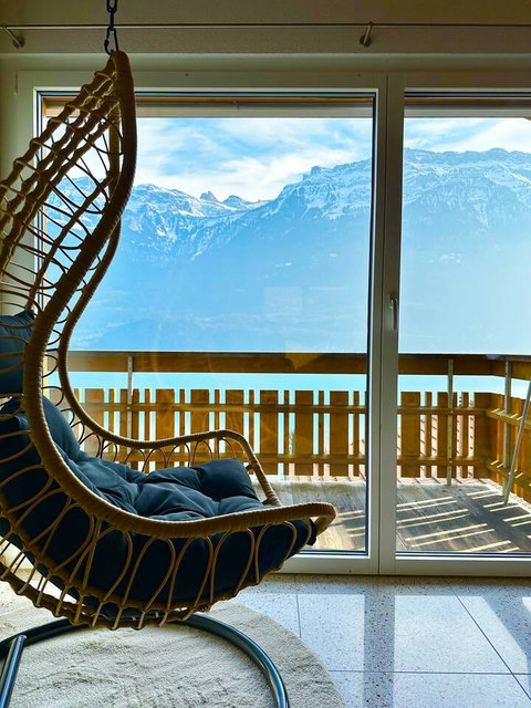 Your Private Corner of Heaven! Sink into the cozy hanging chair and lose yourself in the unparalleled views of the Swiss Alps. Found in one of our attic bedrooms, this is the perfect spot for quiet reflection.