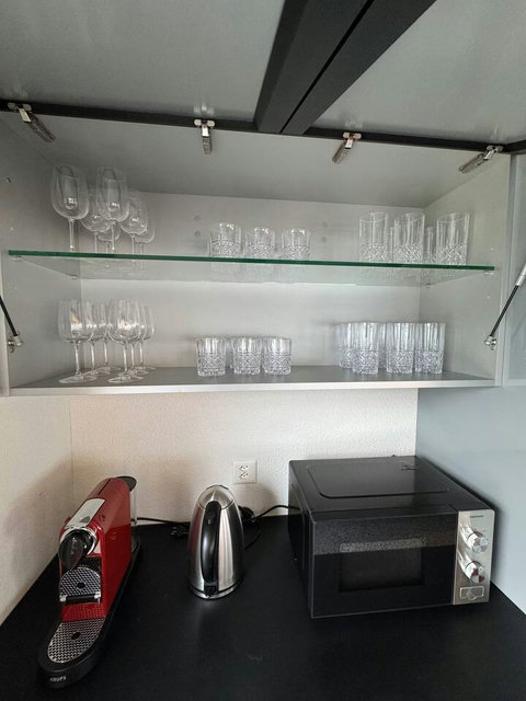 Premium Bar Setup. Wine glasses, tumblers, and beverage essentials are fully stocked. Includes a convenient iron/board for all your travel needs.