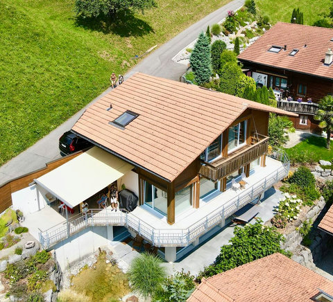 Exclusive Multi-Level Estate! This aerial view captures the full scale of Chalet Swiss Dream, highlighting the expansive terraces, private garden, and ornamental pond. Experience true Alpine luxury and privacy a defining feature of Swiss Dream Living
