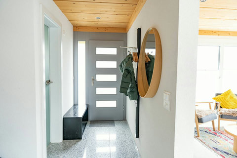 Welcome Home to Chalet Swiss Dream.  A clean, organized entryway featuring modern design, a convenient bench, and coat rack. Step inside and feel instantly at ease. The perfect beginning and end to every day of your Swiss Dream Living retreat.