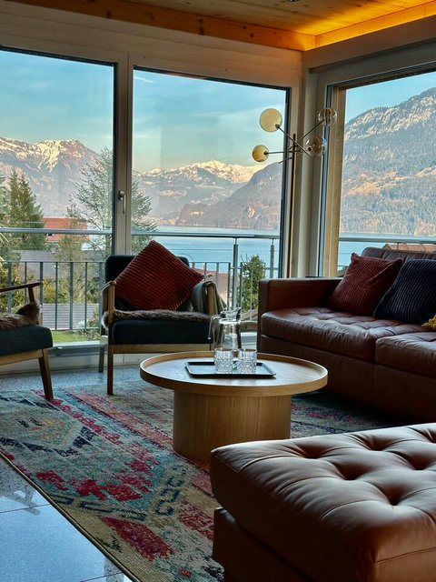 Golden Hour Grandeur!  Witness the magnificent Swiss Alps and Lake Brienz bathed in the warm, golden light of sunset, all from the comfort of your leather sofa. This exclusive, breathtaking moment defines your Swiss Dream Living retreat.