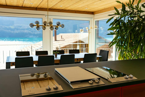 Gourmet Cooking with a View!  Prepare meals on your high-end induction cooktop while enjoying an unparalleled panorama of Lake Brienz. Designer lighting and stunning views elevate every meal prep into a Swiss Dream Living experience.
