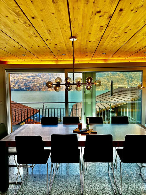 Magical Golden Hour Dining.  The view is truly unparalleled—a feast for the eyes under the warm glow of designer lighting. This is the Swiss Dream Living moment you deserve. Don't just see it, experience it—Book this unforgettable view now!