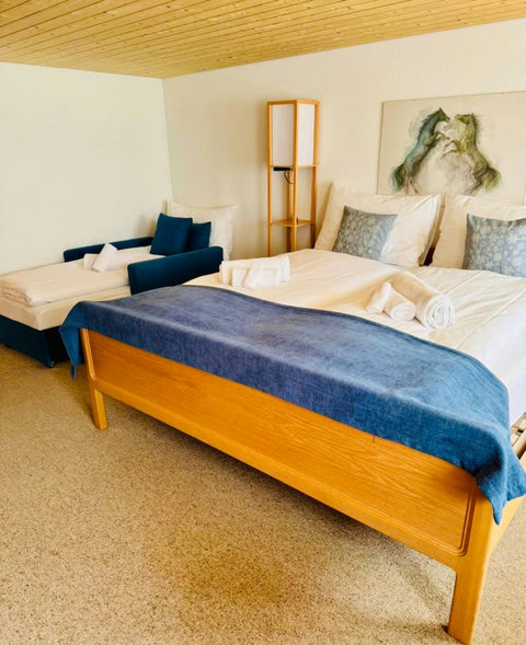 Comfortable bed with fresh linens and cozy pillows for a restful stay.
